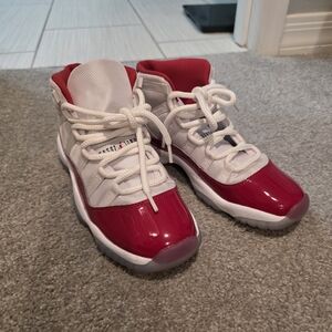 Jordan 11 Retro
Cherry Nike Kids Red and White Sneakers